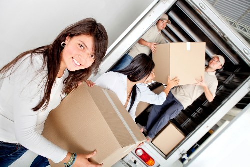 Packed boxes and furniture ready for transport by local movers
